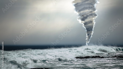 Fotografie, Obraz Dangerous storm with powerful tornado twister over the ocean in the background