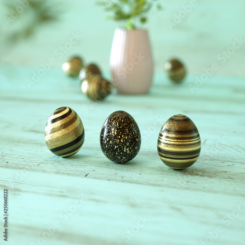 Three golden and black easter eggs on mint green background