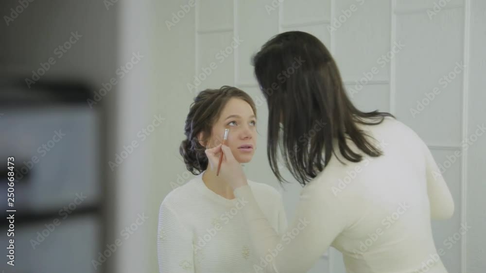 Professional makeup artist makes makeup a very beautiful woman. Professional makeup artist makes makeup a very beautiful woman.