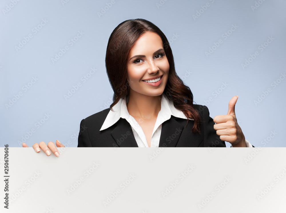 businesswoman showing blank signboard on grey businesswoman showing blank signboard on grey