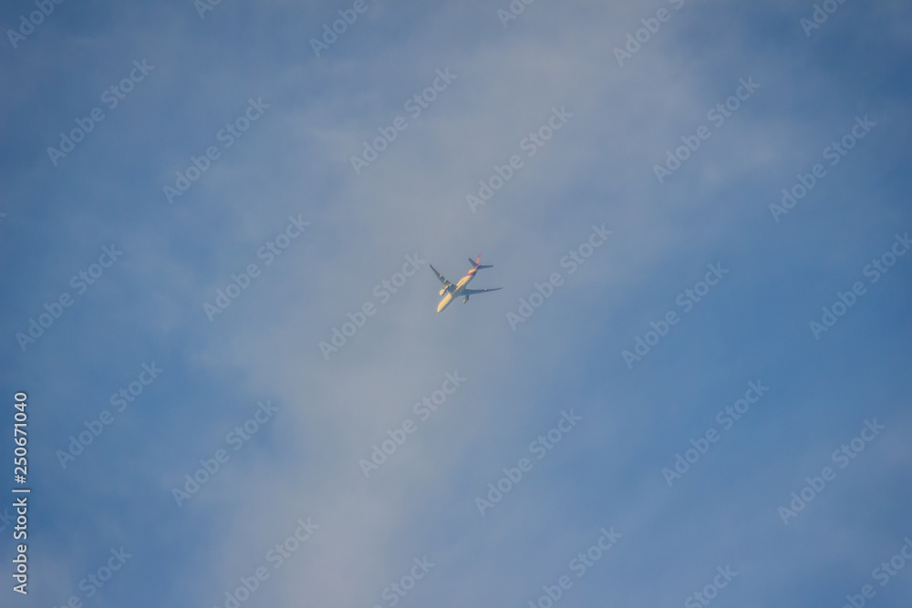 Faraway flying airplane against blue sky and white cloud background. Faraway flying airplane against blue sky and white cloud background.