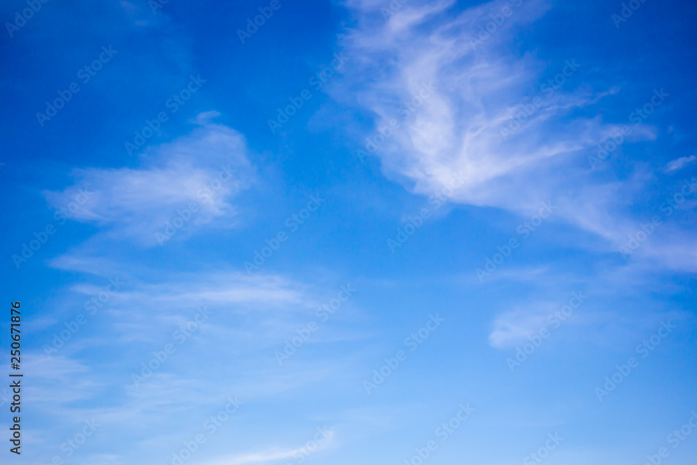 Beautiful blue sky with a small group of clouds background.