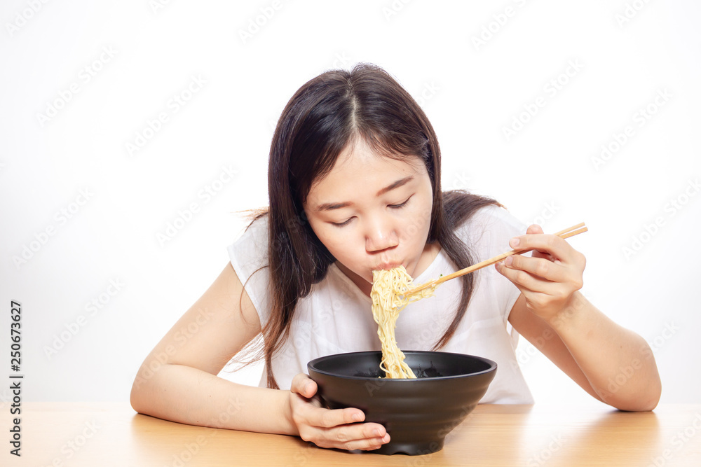 Asian girl enjoy eating delicious noodle close up on white background. Asian girl enjoy eating delicious noodle close up on white background.