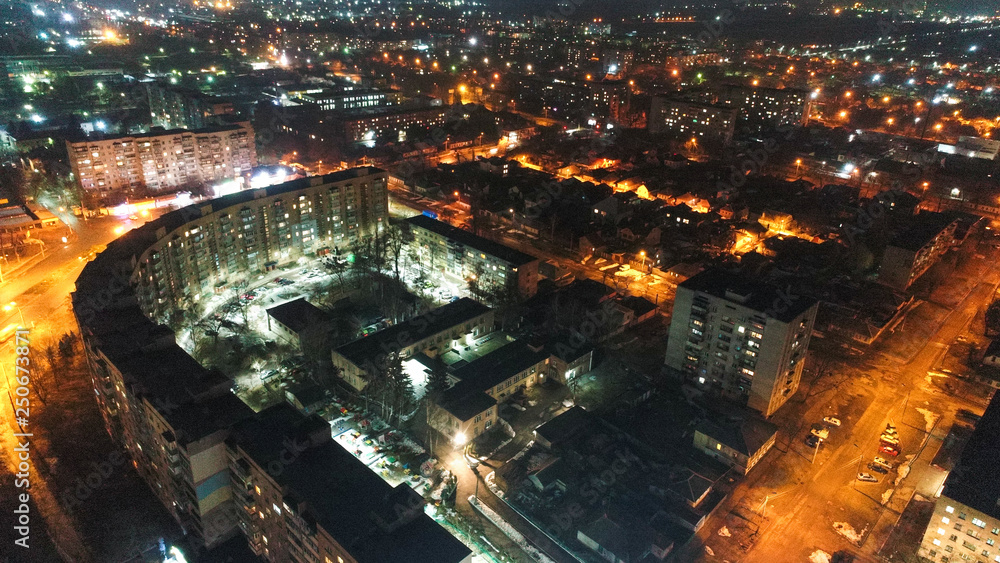 AIR photo of night city , shoted from drone , lot of old buildings and city lights 