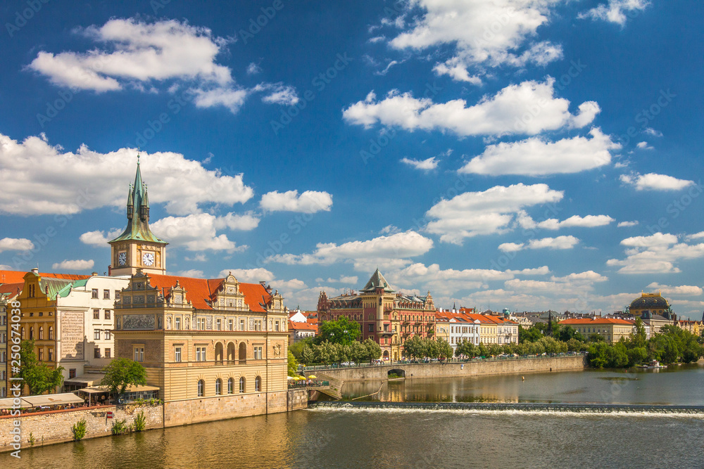 Vltava river and waterfront of the old town with the theater in Prague, Czech Republic, Europe.