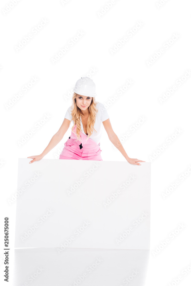 blonde handy woman in pink uniform standing behind empty placard on white background blonde handy woman in pink uniform standing behind empty placard on white background