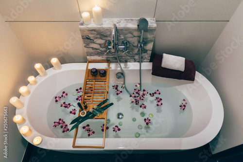 Spa bath with flowers, candles and tray
