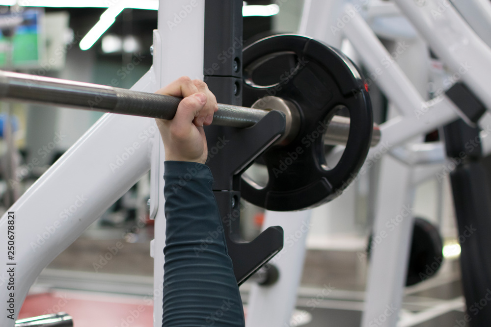 Male hand is holding metal barbell