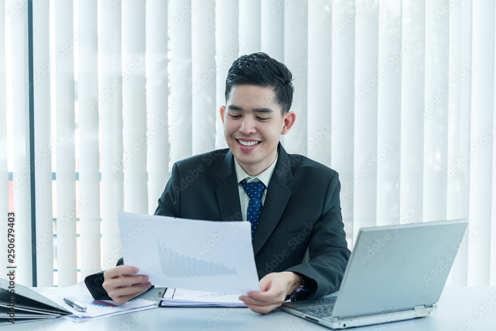 Fototapeta premium Young asian employee working at laptop during working day in office,Businessman happy with smile in the office,thailand people at company