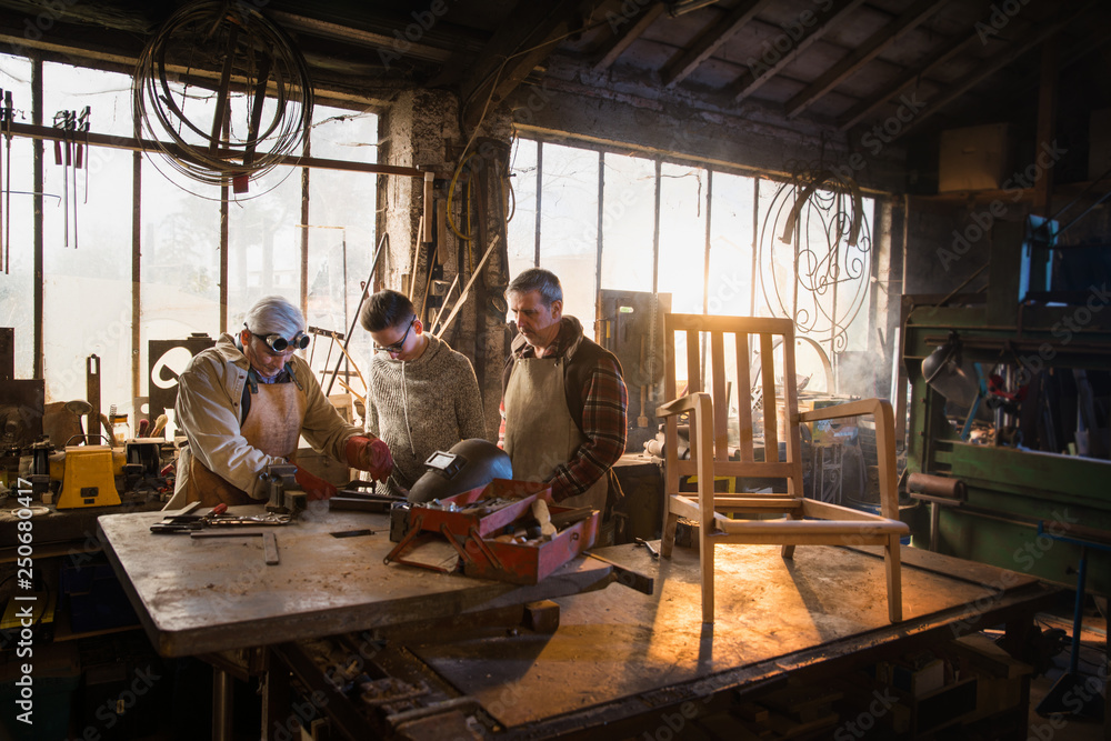 Two craftsmen and their apprentices in their craft workshops Two craftsmen and their apprentices in their craft workshops