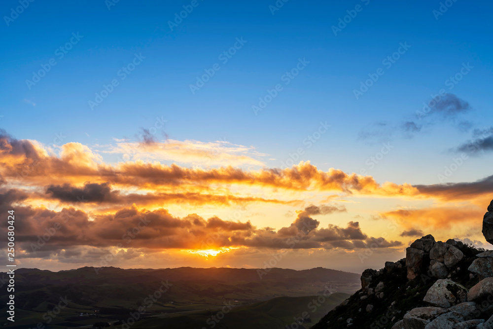 Evening Sun, Clouds, and Mountain Peak