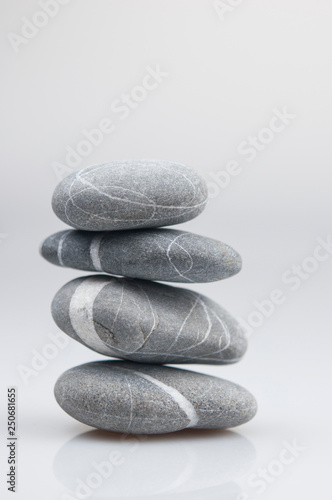 stacked pebbles on white background