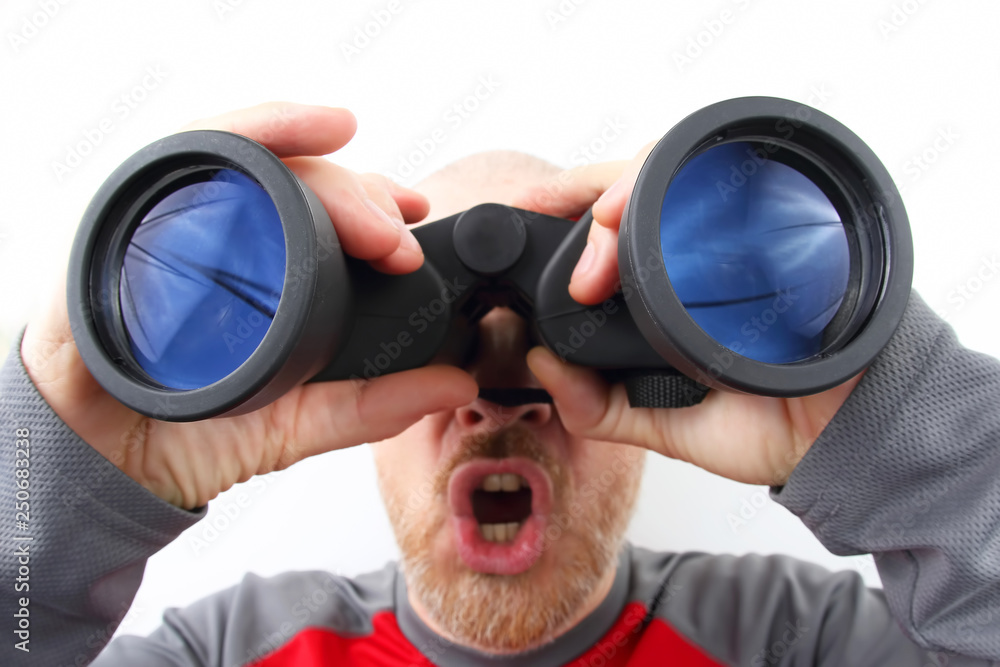 Bearded man looking through binoculars on white background Bearded man looking through binoculars on white background