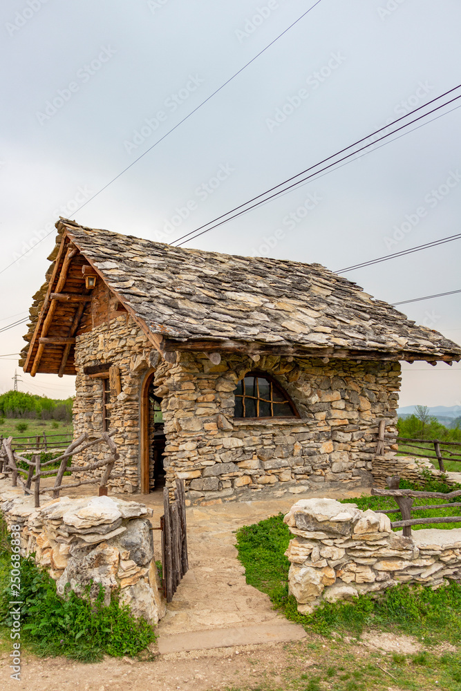 Stone cabin April exterior view, schist roof tiles, in Bulgaria Stock Photo  | Adobe Stock