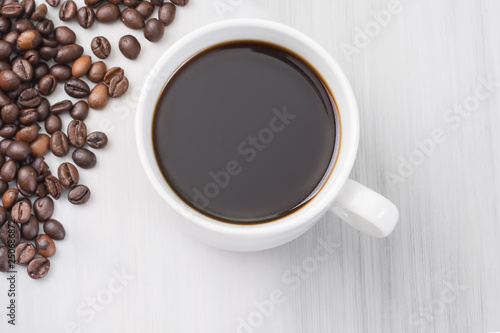 cup of black natural coffee, top view, coffee beans