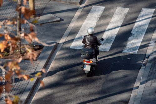 Photography Man in a leather jacket driving a scooter in Barcelona