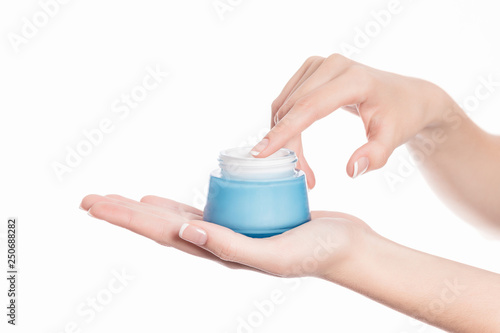 isolated background showing woman hands holding a jar of cream for beauty