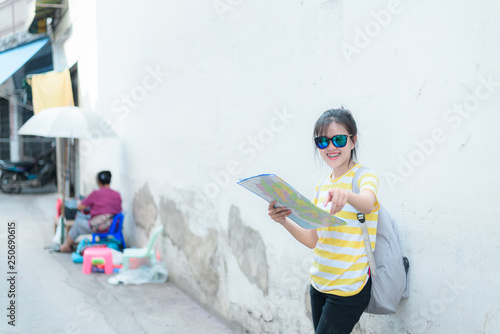 A woman is looking at a map for traveling,traveling in Thailand,traveling in Chiang mai