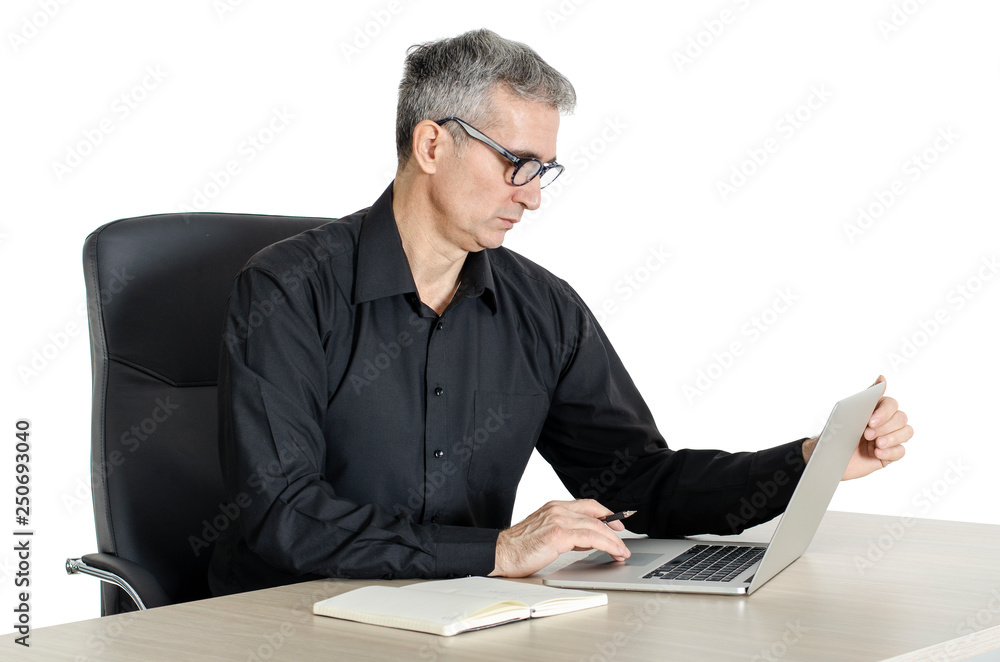 Senior businessman working at his desk in the office Senior businessman working at his desk in the office