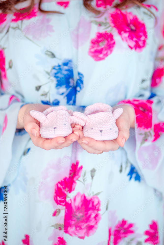 happy pregnant woman holding booties. Horizontal photo happy pregnant woman holding booties. Horizontal photo
