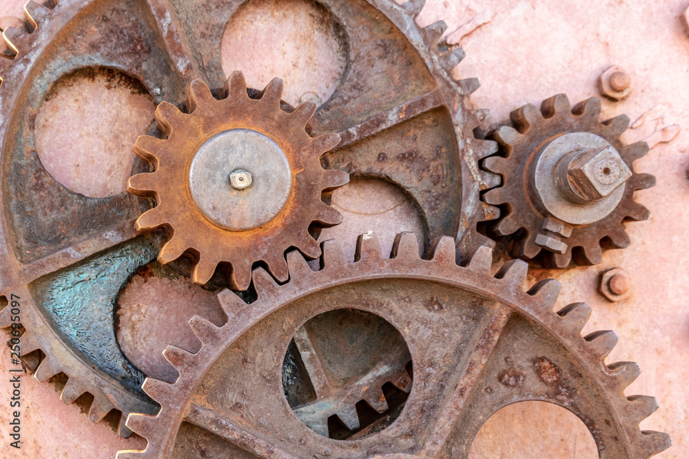 Set of gears, bearings, rusty iron screws forming part of a crane from the beginning of the last century Set of gears, bearings, rusty iron screws forming part of a crane from the beginning of the last century
