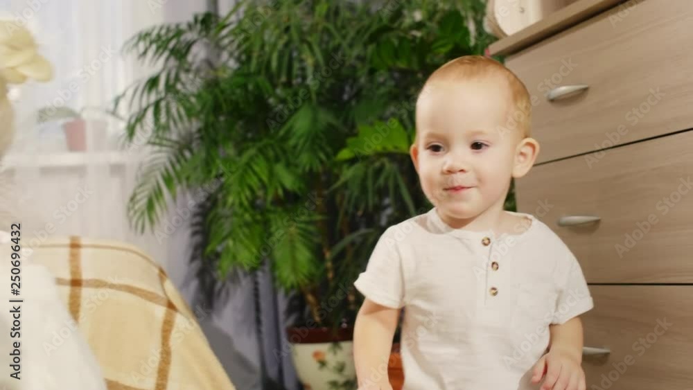 Cute baby boy smiling and walking to grandmother while playing together at home Cute baby boy smiling and walking to grandmother while playing together at home