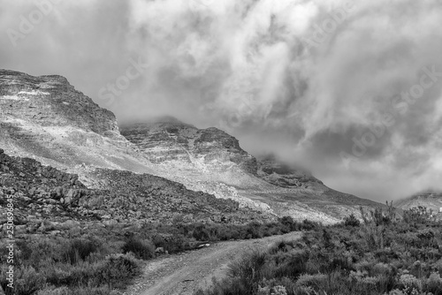 Snow is visible on the mountains at Kromrivier. Monochrome