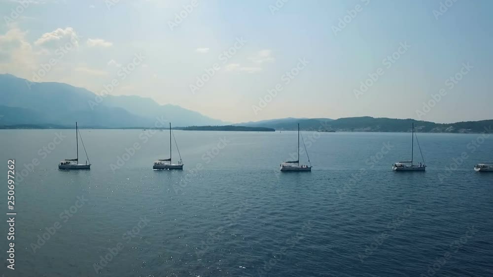 Aerial. Five yachts lined up on Adriatic sea in Montenegro Aerial. Five yachts lined up on Adriatic sea in Montenegro