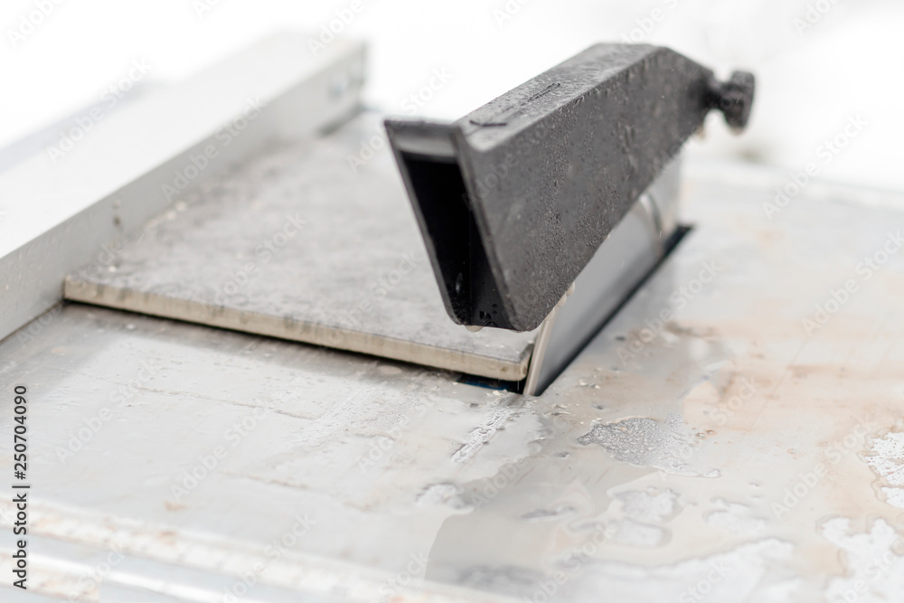 water is supplied to the electric machine. Master cuts the tile. close-up water is supplied to the electric machine. Master cuts the tile. close-up