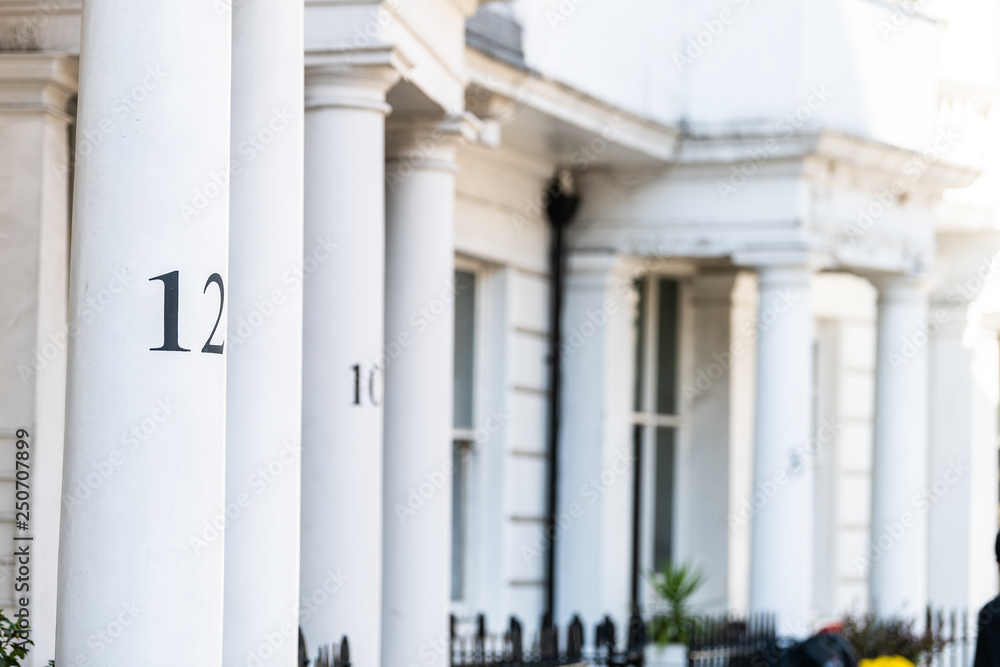 London neighborhood district of Pimlico with terraced housing balconies buildings and numbers on columns closeup in old vintage historic traditional style flats London neighborhood district of Pimlico with terraced housing balconies buildings and numbers on columns closeup in old vintage historic traditional style flats