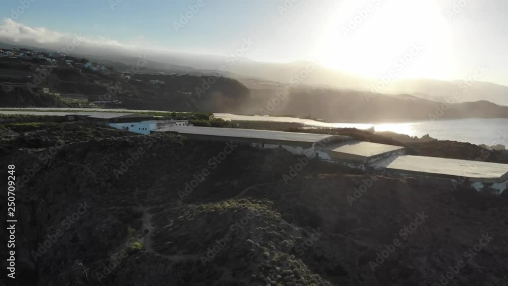 Sunset in the coast of Tenerife north with volcano stones and banana trees. Aerial footage with a drone Sunset in the coast of Tenerife north with volcano stones and banana trees. Aerial footage with a drone