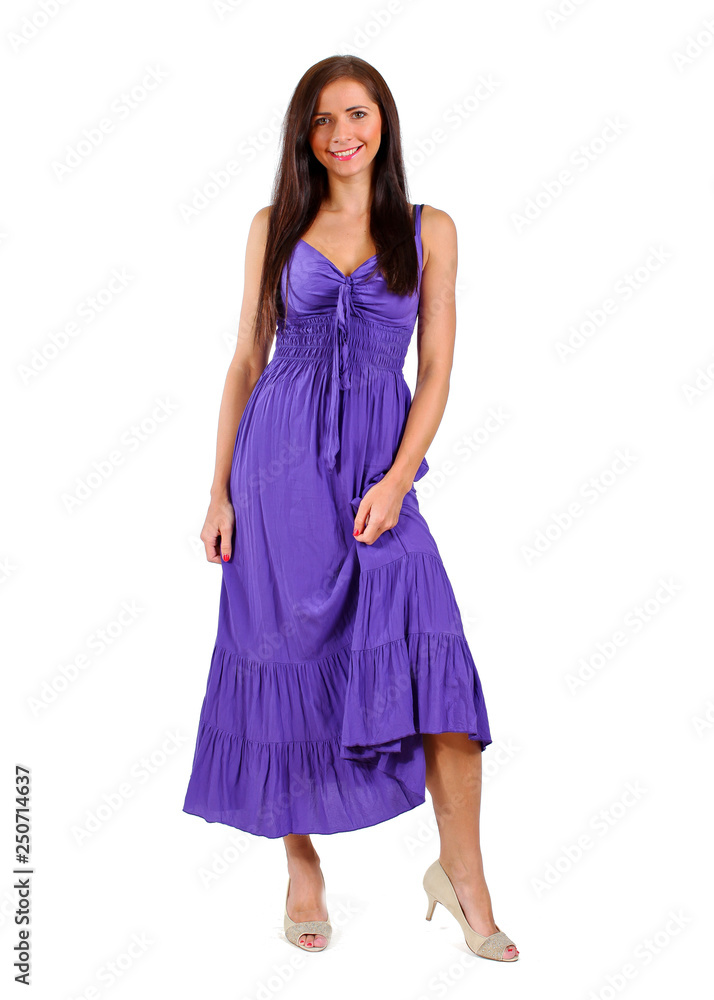 Young brunette woman in purple / violet dress isolated on white background.