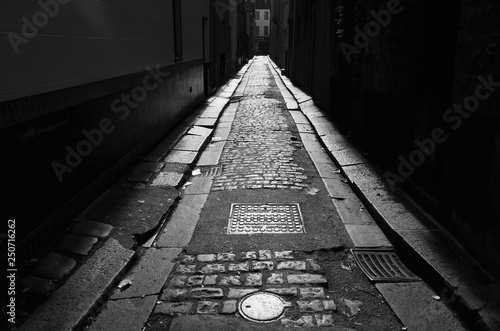 Urban alley, Jersey, U.K. B&W gritty backstreet. photo