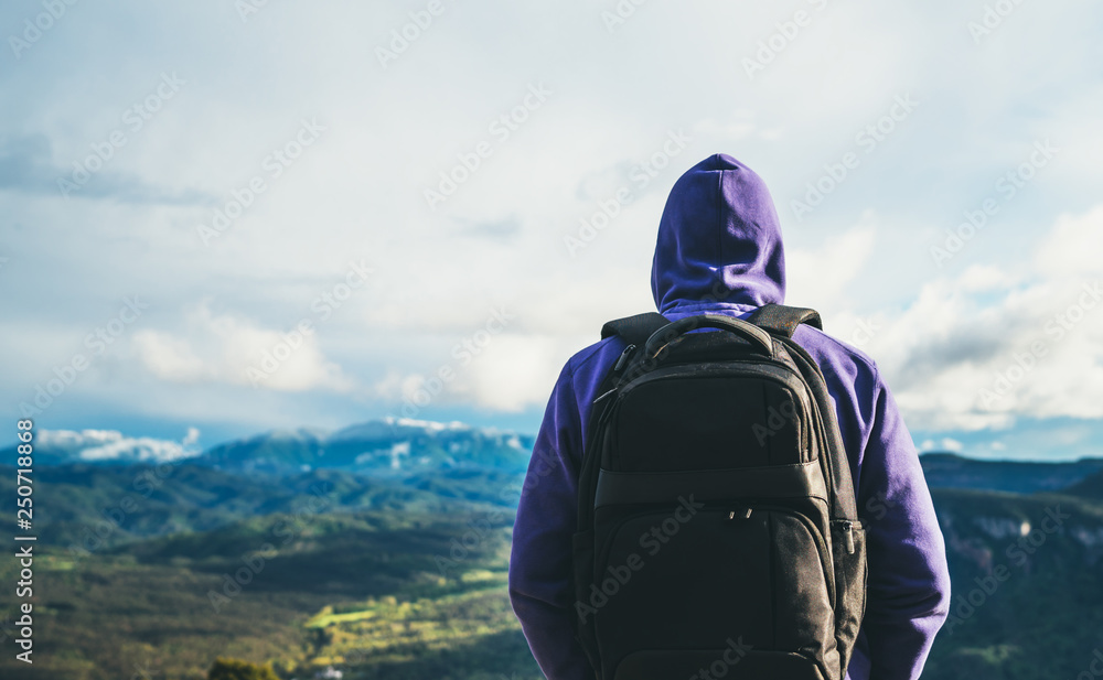 tourist traveler with black backpack on background top mountain, traveler look at blue sky clouds, hiker enjoying nature panoramic landscape in trip, relax holiday mockup concept in trekking trip tourist traveler with black backpack on background top mountain, traveler look at blue sky clouds, hiker enjoying nature panoramic landscape in trip, relax holiday mockup concept in trekking trip