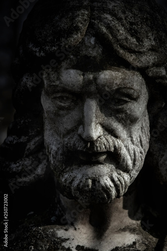 Close up stone antique statue of Jesus Christ. Religion, faith, death, resurrection, eternity concept.