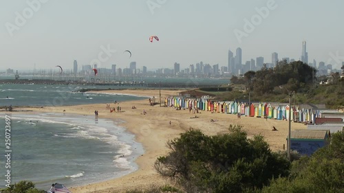 WS Brighton Beach with beach huts and kite surfers, downtown skyline in background / Melbourne, Australia