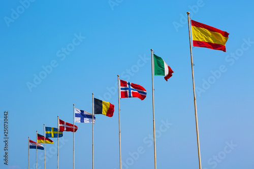 Flags of European countries waving on blue sky