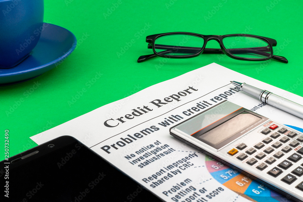 Credit report on the green table and a pen. Credit report on the green table and a pen.