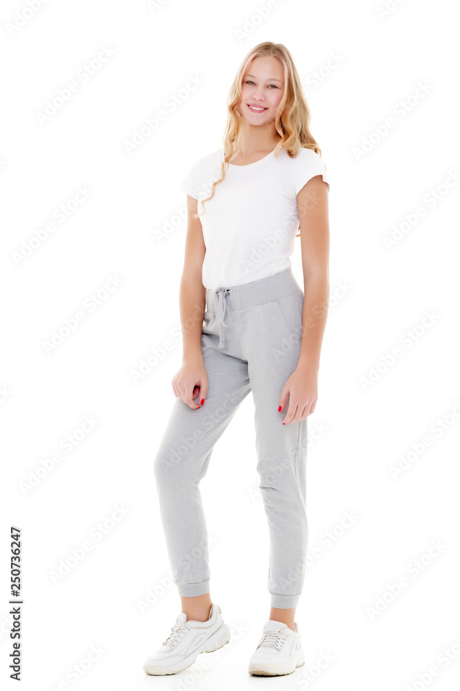 Fototapeta premium Little school girl pointing to her empty white t-shirt.