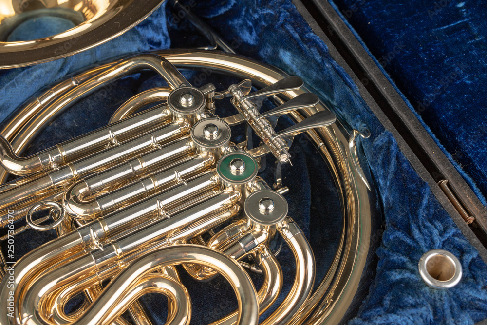 French horn in an old case on a wooden table. Beautiful polished musical  instrument. Stock Photo | Adobe Stock