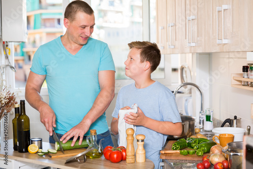 Konstfotografi Man with his son are cooking soup in the kitchen