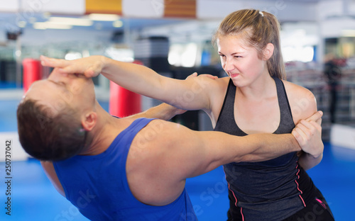 Fitness woman and her trainer are exercise punches