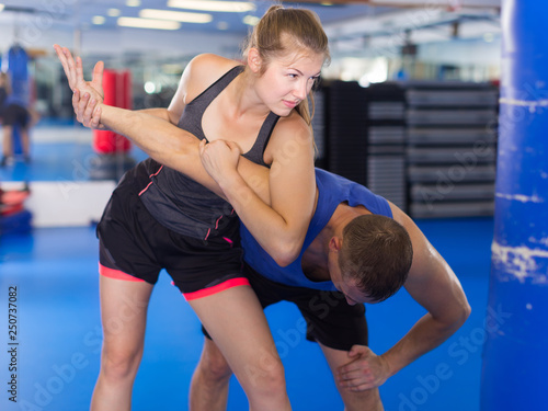 Glad female is fighting with trainer