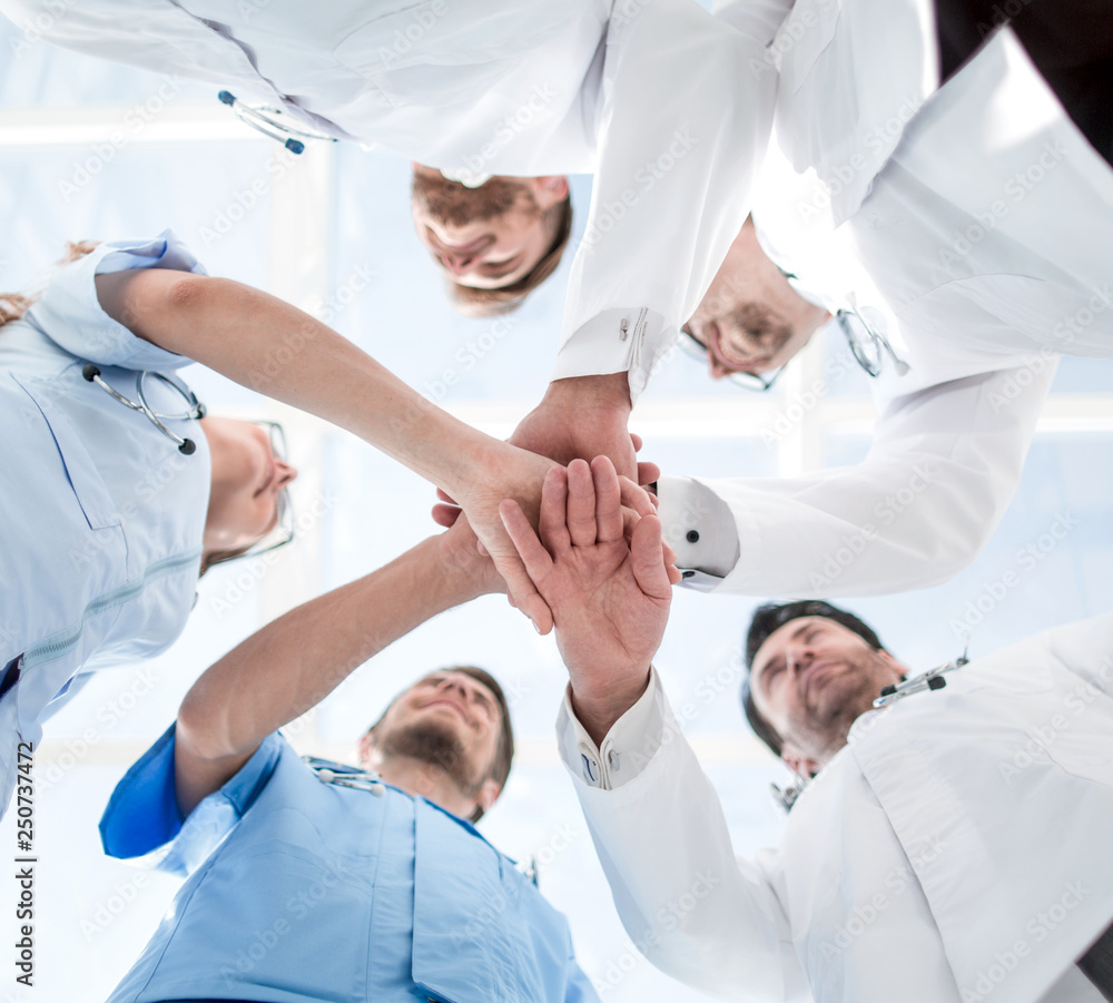 Obraz premium Health care workers demonstrating unity, bottom view