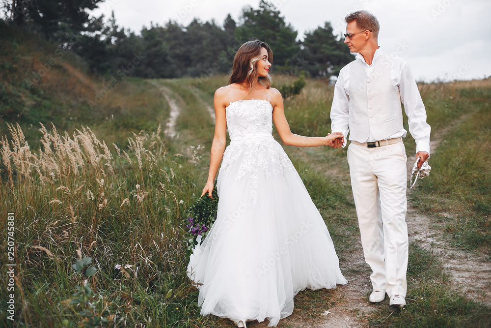 Beautiful wedding couple in a summer field