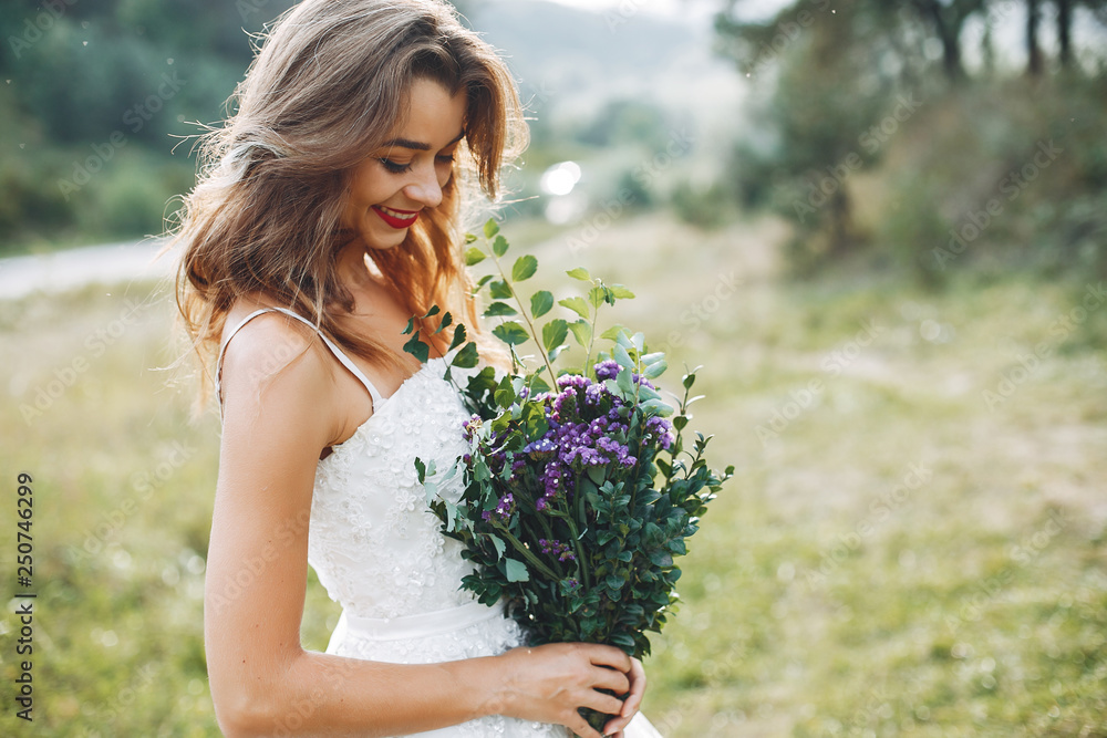 Beautiful bride walking in a summer field Beautiful bride walking in a summer field