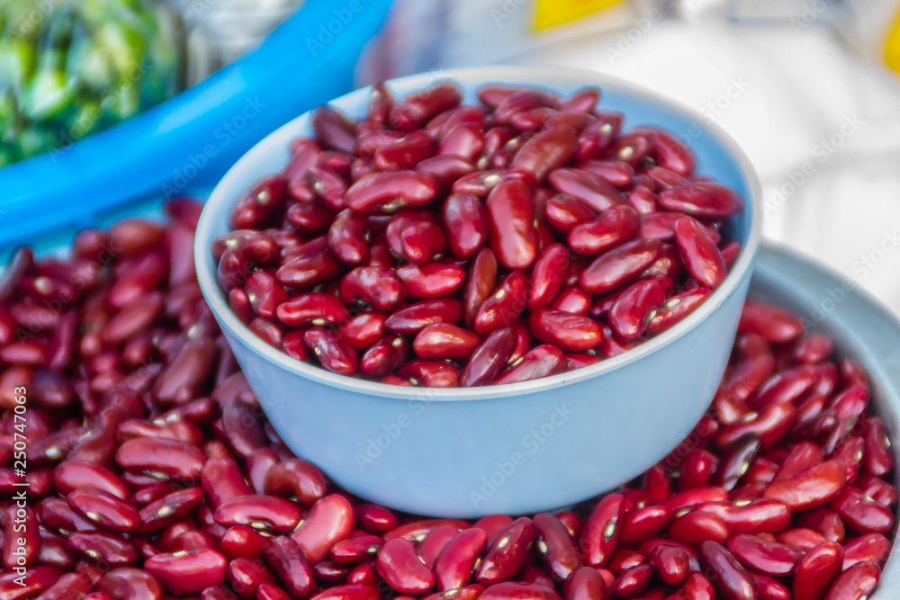 Red kidney beans with measure out bowl for sale in the market. Kidney bean is a variety of the common bean (Phaseolus vulgaris). It is named for its visual resemblance in shape and colour to a kidney. Red kidney beans with measure out bowl for sale in the market. Kidney bean is a variety of the common bean (Phaseolus vulgaris). It is named for its visual resemblance in shape and colour to a kidney.