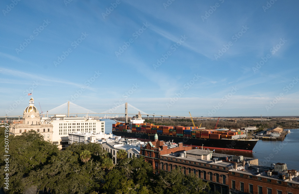 Cityscape of Savannah Georgia riverfront with large freight ship