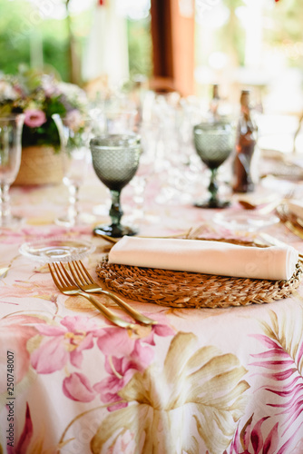Elegant cutlery and floral arrangements for a table in a wedding restaurant with vintage style centerpieces.