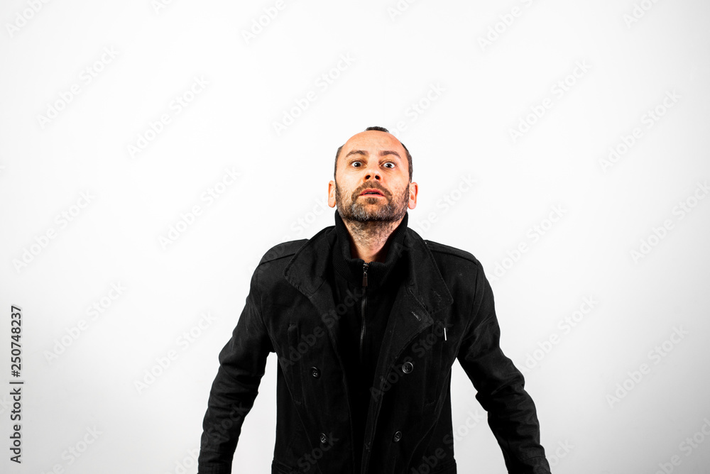 Middle-aged man in black coat making obscene gestures Middle-aged man in black coat making obscene gestures